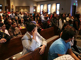 A congregation in prayer at Mass. Corbis photo by Andrew Lichtenstein for illustrative purposes only.