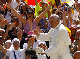 Pope Francis waves to the crowds gathered for one of his weekly audiences.