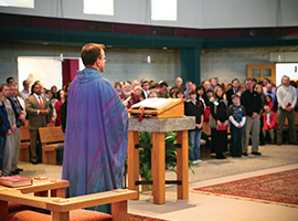 A priest leads a congregation at Mass. USCCB photo by Maria Pope.