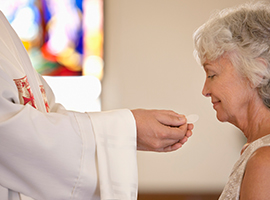 A woman receives the Eucharist.