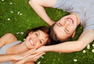 smiling young couple grass iStock home