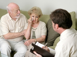 A grieving couple meets with a counselor. iStock photo.