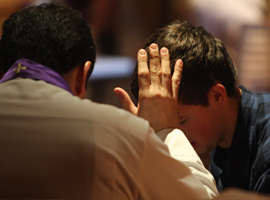 A young penitent receives absolution. CNS Photo/Gregory A. Shemitz