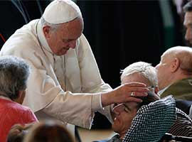 Pope Francis blesses a man while greeting the disabled at Queen of Peace Parish in Ostia on the outskirts of Rome. CNS photo/Paul Haring