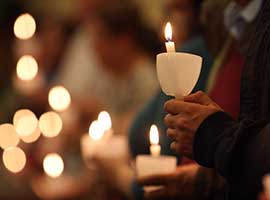 Worshippers hold candles during an Easter Vigil at St. Jude Church in Mastic Beach, N.Y. CNS photo/Gregory A. Shemitz