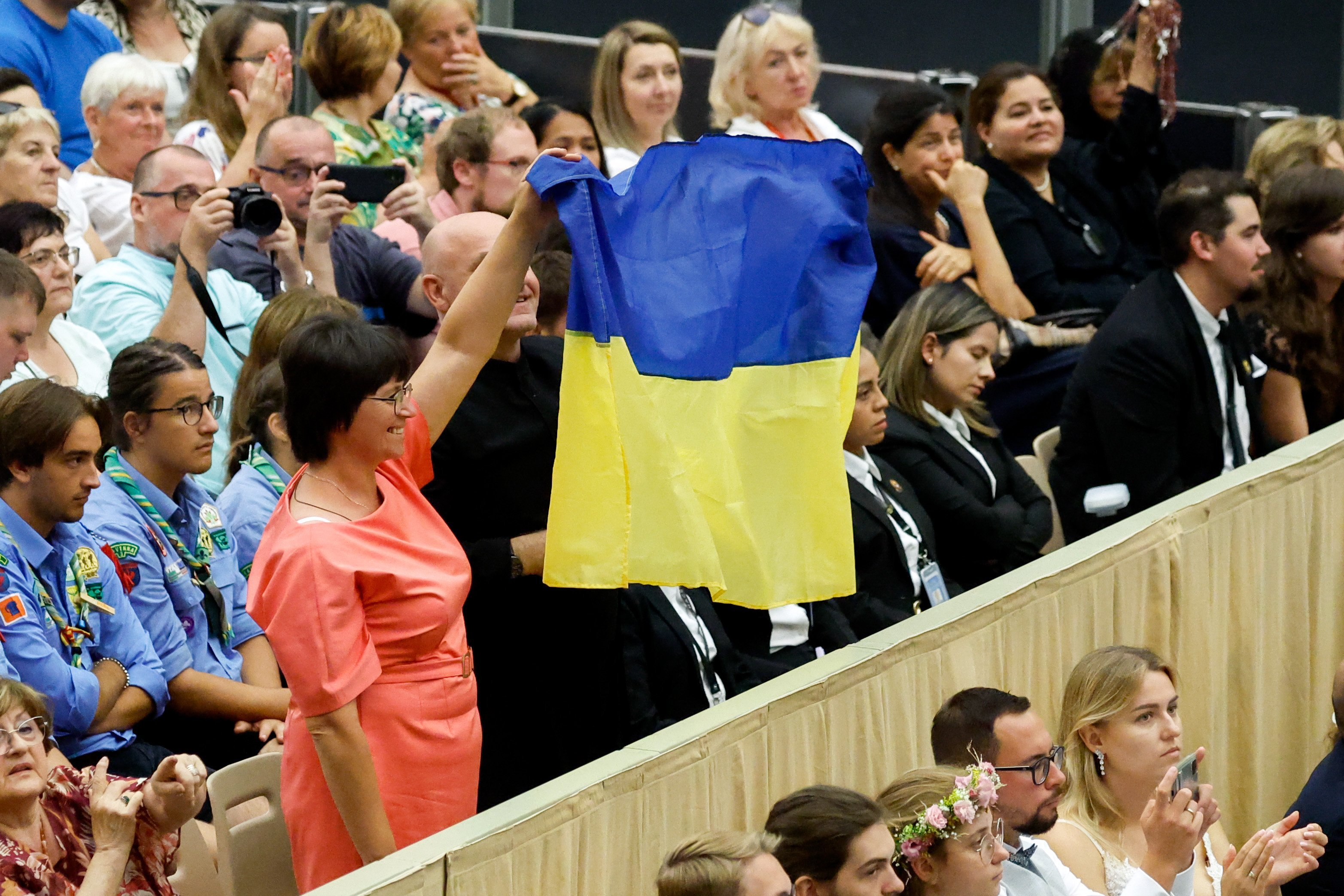People hold up a Ukrainian flag at the pope's general audience.