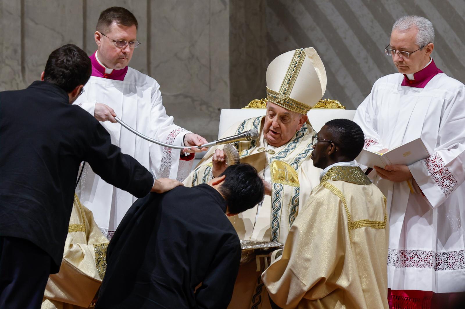 Pope Francis baptizes a man at the Easter vigil