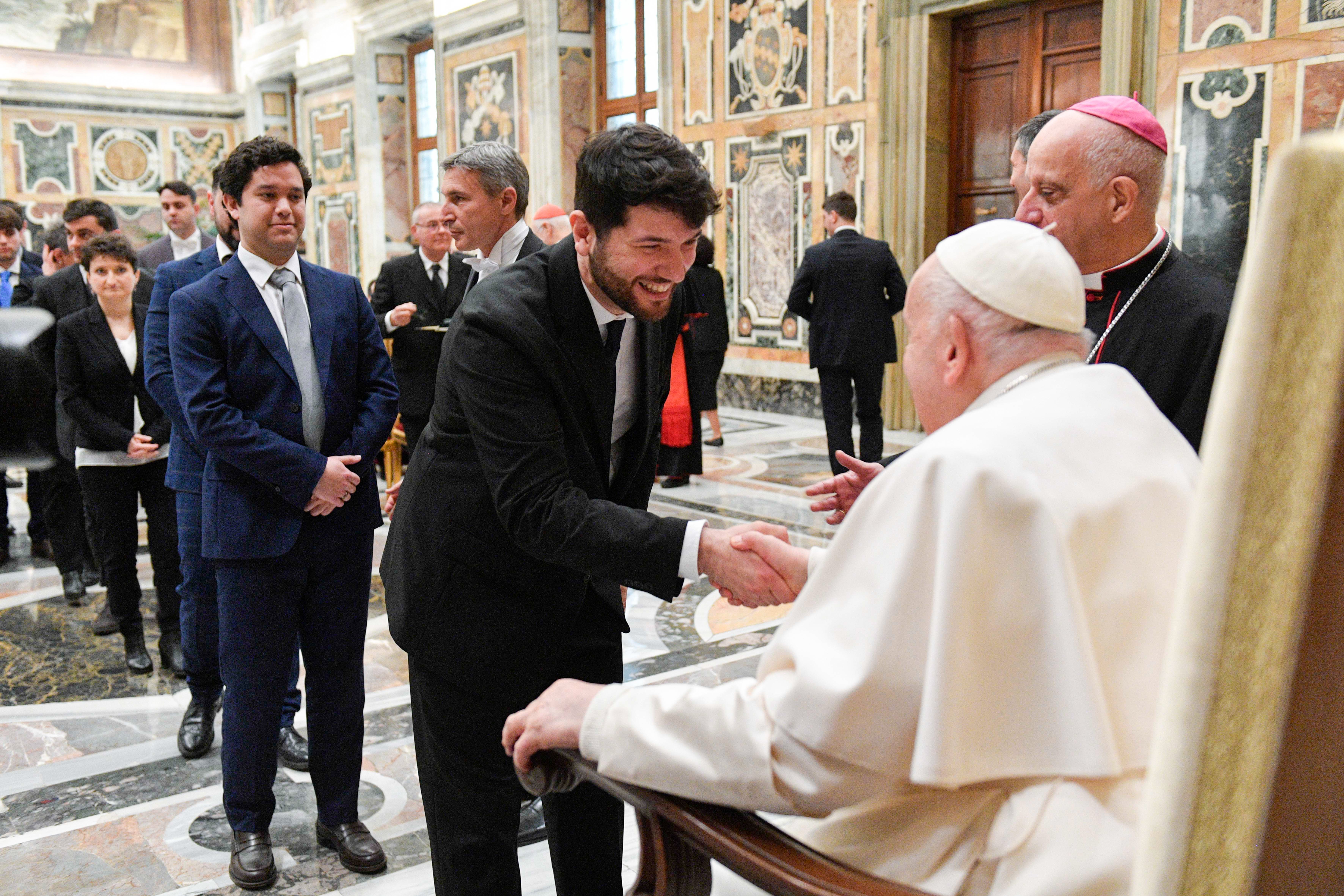 Pope Francis greets a member of the Dicastery for Evangelization.