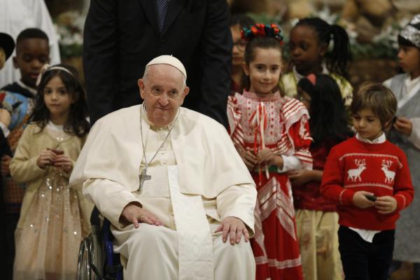 Pope Francis walks with children after Christmas Mass