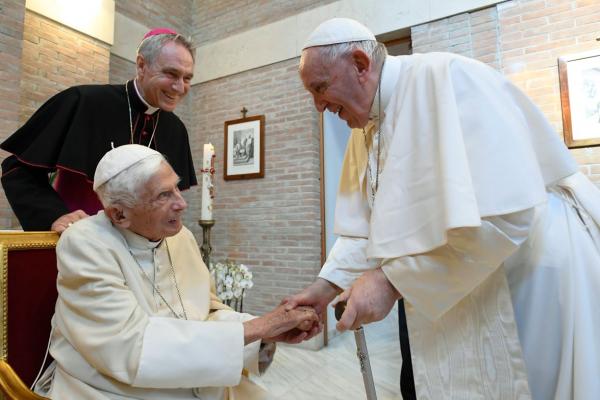 Pope Francis and retired Pope Benedict greeting one another in August.