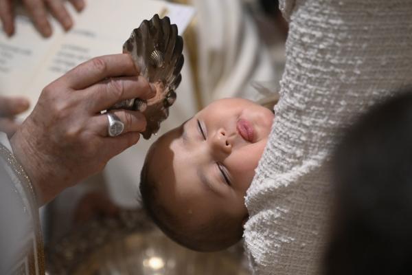 Pope Francis baptizes a baby