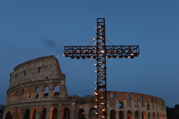A cross stands in front of Rome's Colosseum