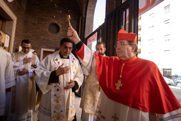 Cardinal Christophe Pierre sprinkles holy water.