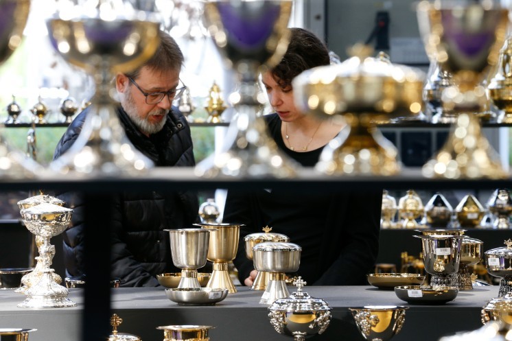 Shoppers look at chalices.